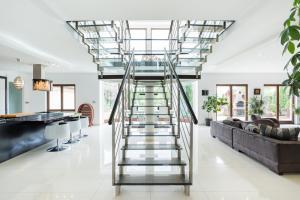 open plan home with glass and stainless steel stair handrails